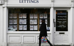 A woman walks past an estate agent in Chelsea, London, in this file photograph dated February 7, 2013. They have pocketed some of the most lucrative returns available to investors in recent decades and been a staple of newspapers' personal finance pages, but tougher times now lie ahead for Britain's army of small-time landlords.   REUTERS/Stefan Wermuth/Files